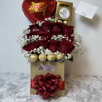 Red rose gift box with a birthday balloon and chocolates