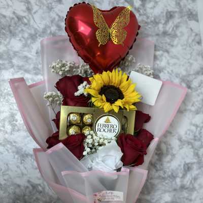 Bouquet of red roses with a sunflower, chocolate box, and heart balloon