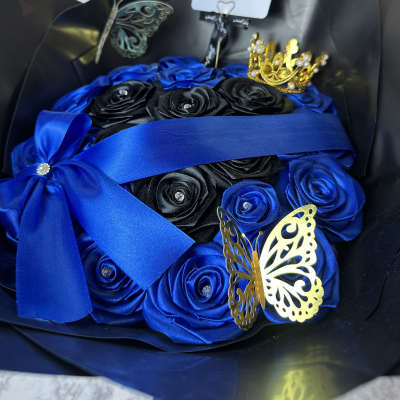 Blue and black rose bouquet with butterfly decorations and ribbon