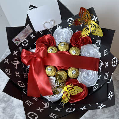 Bouquet of satin roses with chocolates and butterfly accents