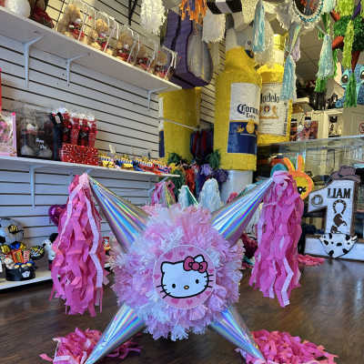 Hello Kitty party piñata with pink tassels and iridescent cones