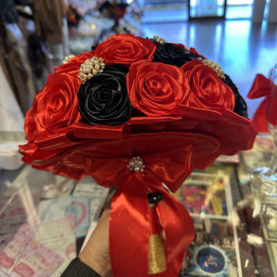 Bouquet of red and black roses with a red satin ribbon