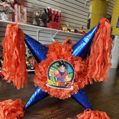 Dragon Ball Z piñata with orange streamers and blue foil points