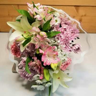 Bouquet of pink and white flowers wrapped in sheer paper