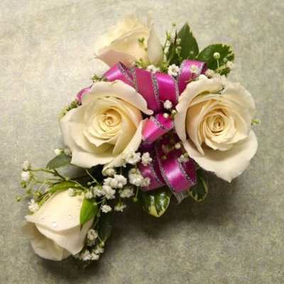 Cream rose corsage with pink ribbon and baby's breath
