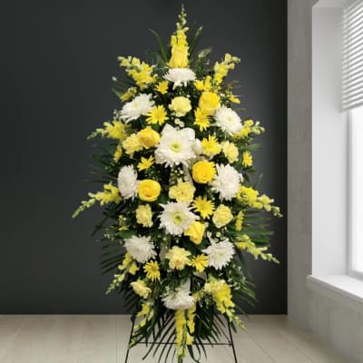 Tall yellow and white floral standing spray on an easel