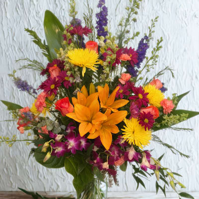Mixed bouquet with orange lilies, yellow mums, and purple orchids