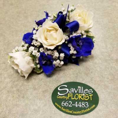 Blue and white rose corsage with ribbon and baby's breath
