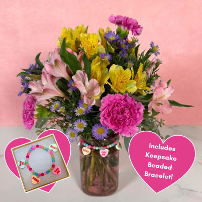 Mixed bouquet in a glass jar with a beaded bracelet gift