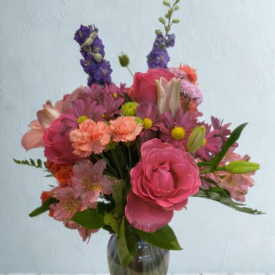 Pink and purple mixed bouquet in a glass vase