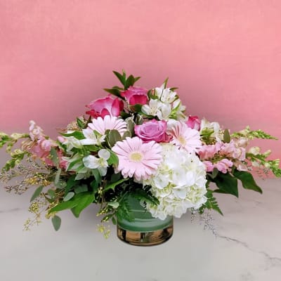 Pink and white mixed flower arrangement in a glass vase