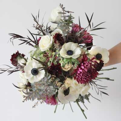 Bouquet of white and magenta flowers with dark foliage