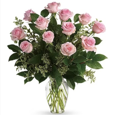 Pink roses arranged in a clear glass vase