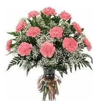 Pink carnations and baby's breath in a clear glass vase