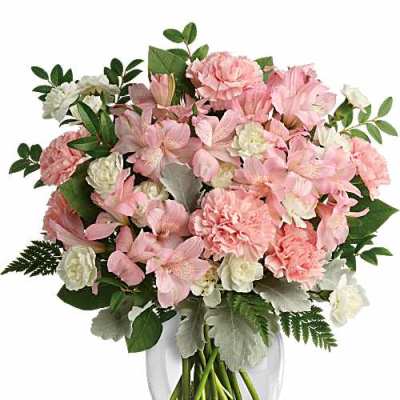Pink and white flowers arranged in a clear glass vase
