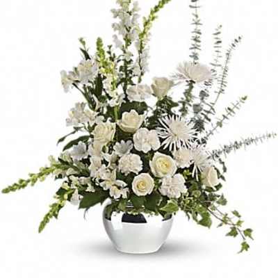 White floral arrangement in a silver vase with tall spiky accents