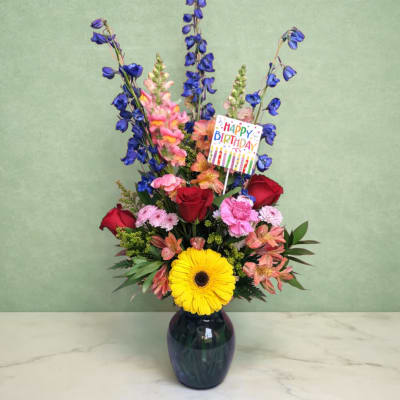 Mixed bouquet in a dark vase with a Happy Birthday card