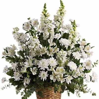 White floral arrangement in a woven basket