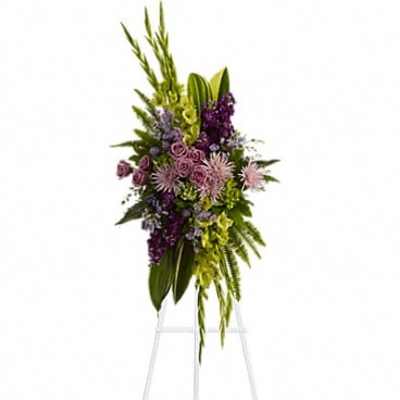 Tall purple and green floral spray on a stand