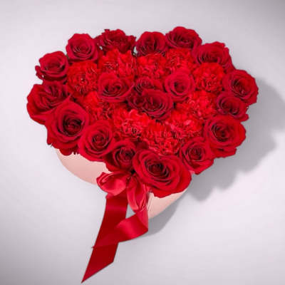 Heart-shaped bouquet of red roses with a red ribbon