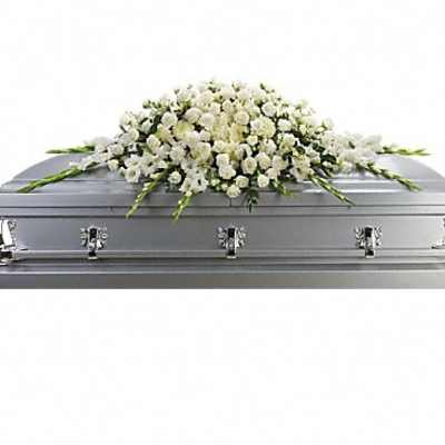 White floral spray on a silver casket