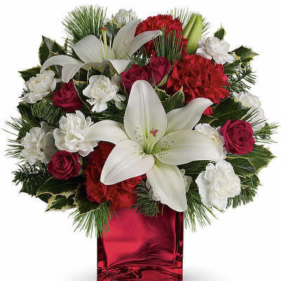 Red and white floral arrangement in a red glass vase