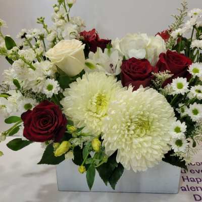 Red roses and white chrysanthemums in a rectangular vase