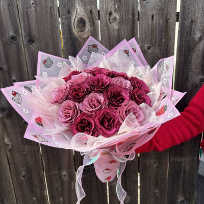 Pink rose bouquet wrapped in Hello Kitty paper with ribbon