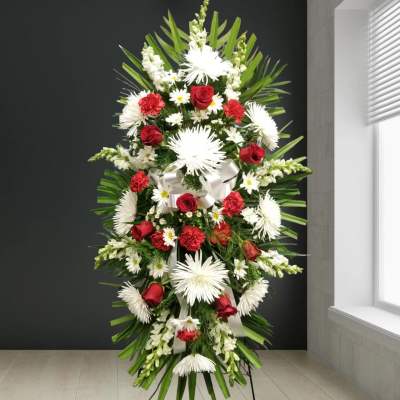 Tall standing floral spray with red roses and white daisies