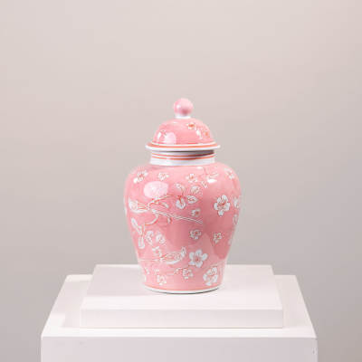Pink ceramic lidded jar with white floral and bird pattern