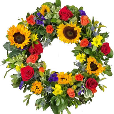 Circular wreath of sunflowers and roses with mixed greenery