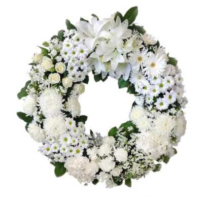 White floral wreath with lilies, daisies, and roses