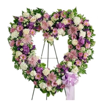 Heart-shaped floral wreath on an easel with a lavender ribbon