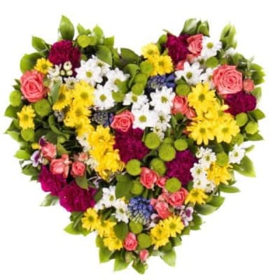 Heart-shaped bouquet of mixed flowers in pink, yellow, white, and purple