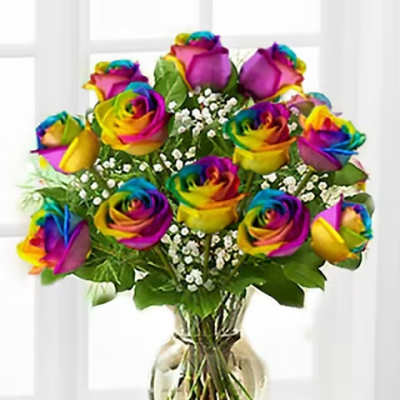 Bouquet of rainbow-colored roses in a clear glass vase