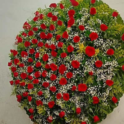 Large standing wreath of red roses with white filler flowers