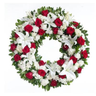Heart-shaped wreath of red roses and white lilies