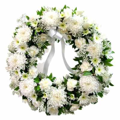 White floral wreath with a silver ribbon bow