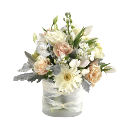 Cream and peach bouquet in a frosted vase with a sheer ribbon