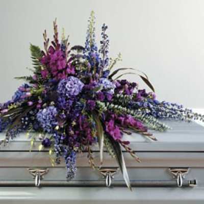 Purple floral spray on a silver casket