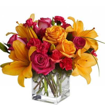 Bouquet of pink and yellow flowers in a clear glass vase