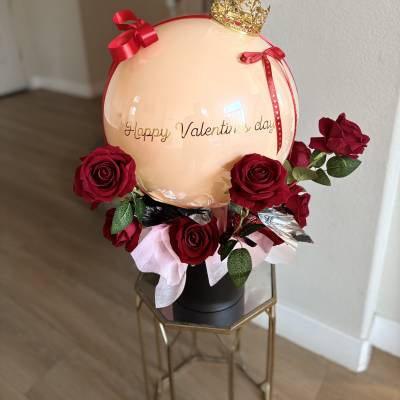 Valentine's Day balloon arrangement with red roses and a gold crown