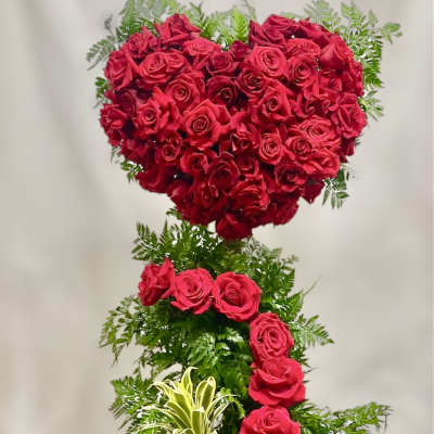 Heart-shaped red rose arrangement in a wooden box
