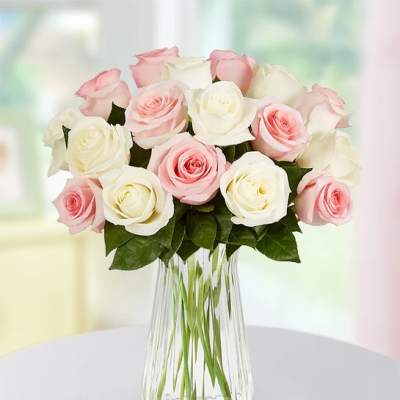 Bouquet of pink and white roses in a clear glass vase