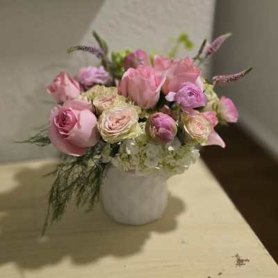 Pink and cream rose bouquet in a white vase