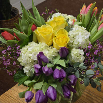 Bouquet of yellow roses, white hydrangeas, and purple tulips