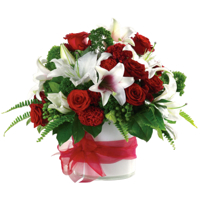 Red roses and white lilies in a glass vase with a red ribbon