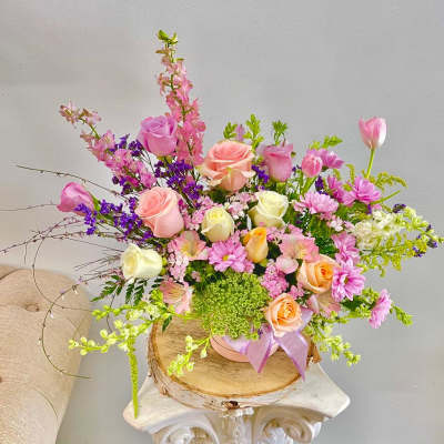 Mixed bouquet of pink and peach roses with purple and white flowers