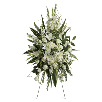 White floral standing spray with lilies and roses on a metal easel