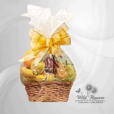 Fruit basket wrapped in clear cellophane with a gold bow